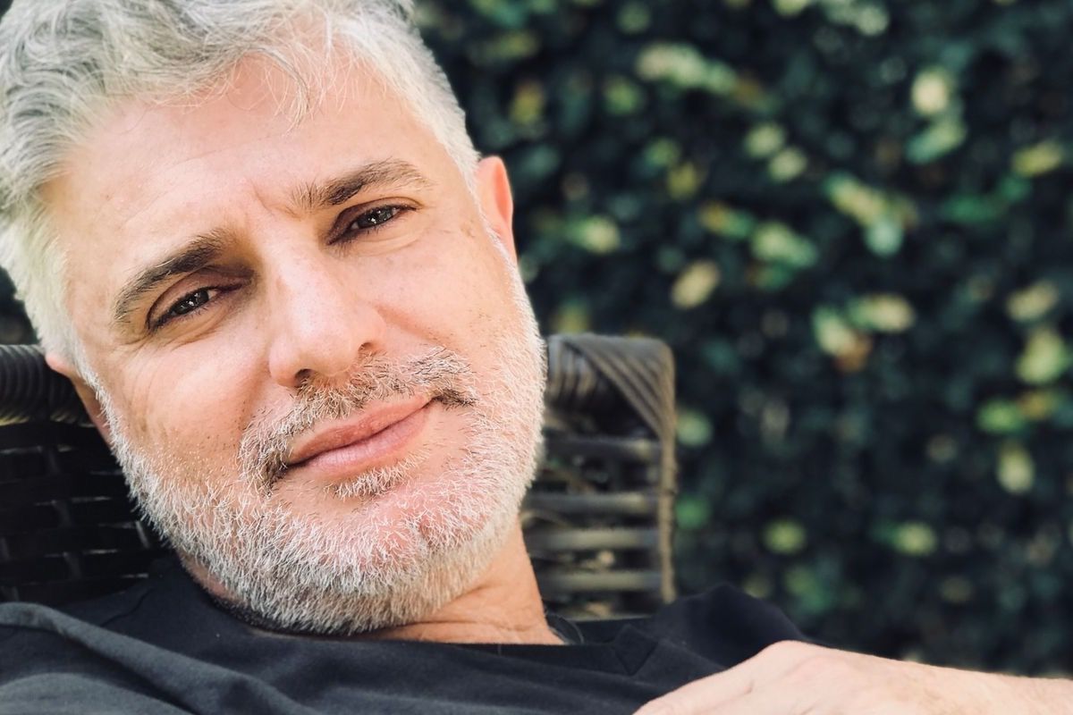 Man over 50 in a relaxed everyday setting, looking comfortable and self-assured